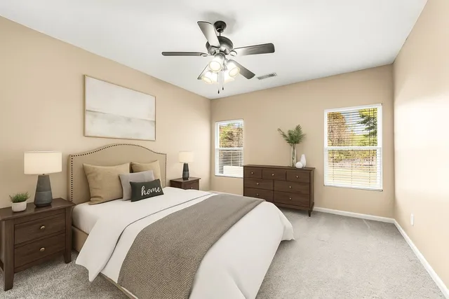 a white bath tub sitting in a bathroom next to a window