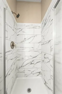 a view of a hallway with wooden floor and closet