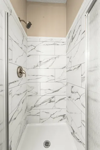 a view of a hallway with wooden floor and closet