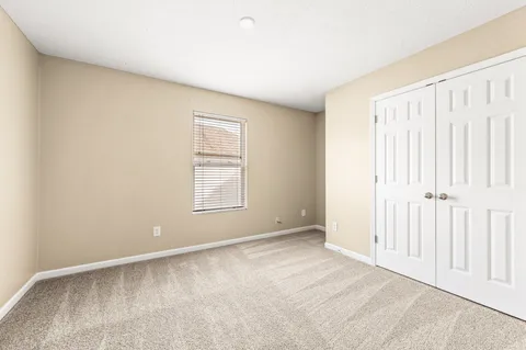 en empty room with ceiling fan and window