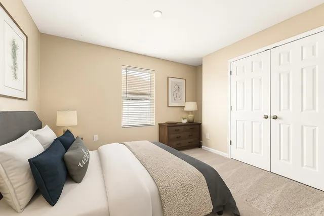 a living room with furniture a ceiling fan and a rug