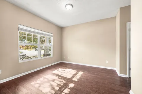 a view of a hallway view with wooden floor and staircase