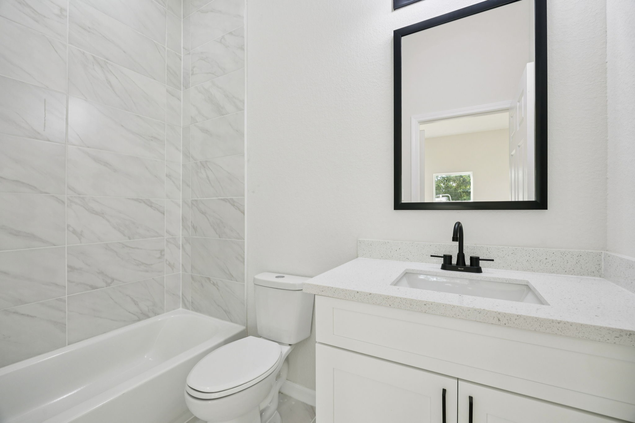 301 Cartersville Street, Unit B Houston, TX 77029 - Photo 11 of 23 a bathroom with a toilet a sink and mirror