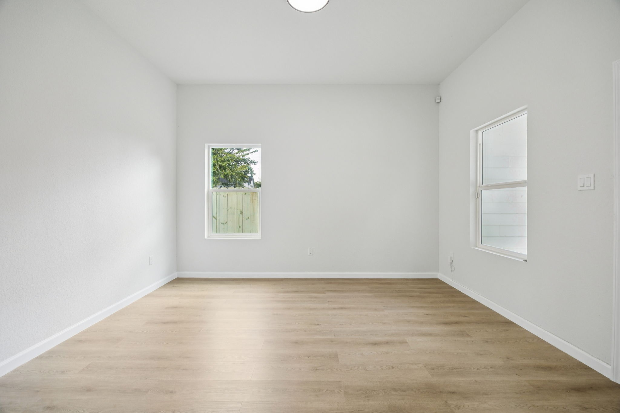 301 Cartersville Street, Unit B Houston, TX 77029 - Photo 14 of 23 an empty room with wooden floor and window