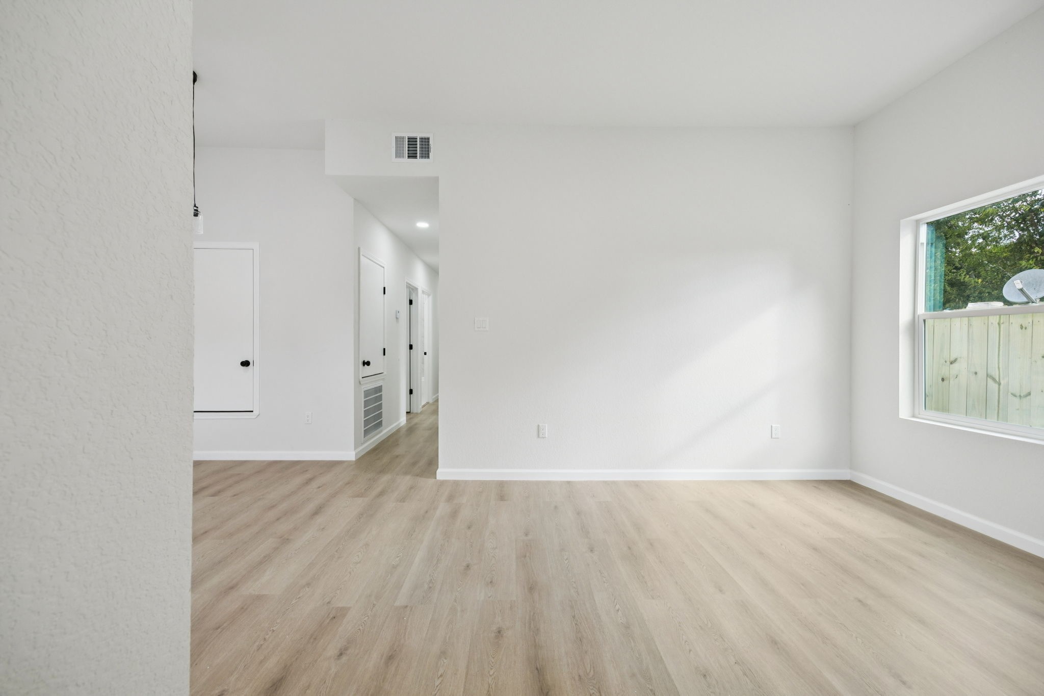 301 Cartersville Street, Unit B Houston, TX 77029 - Photo 20 of 23 a view of an empty room with wooden floor and a window