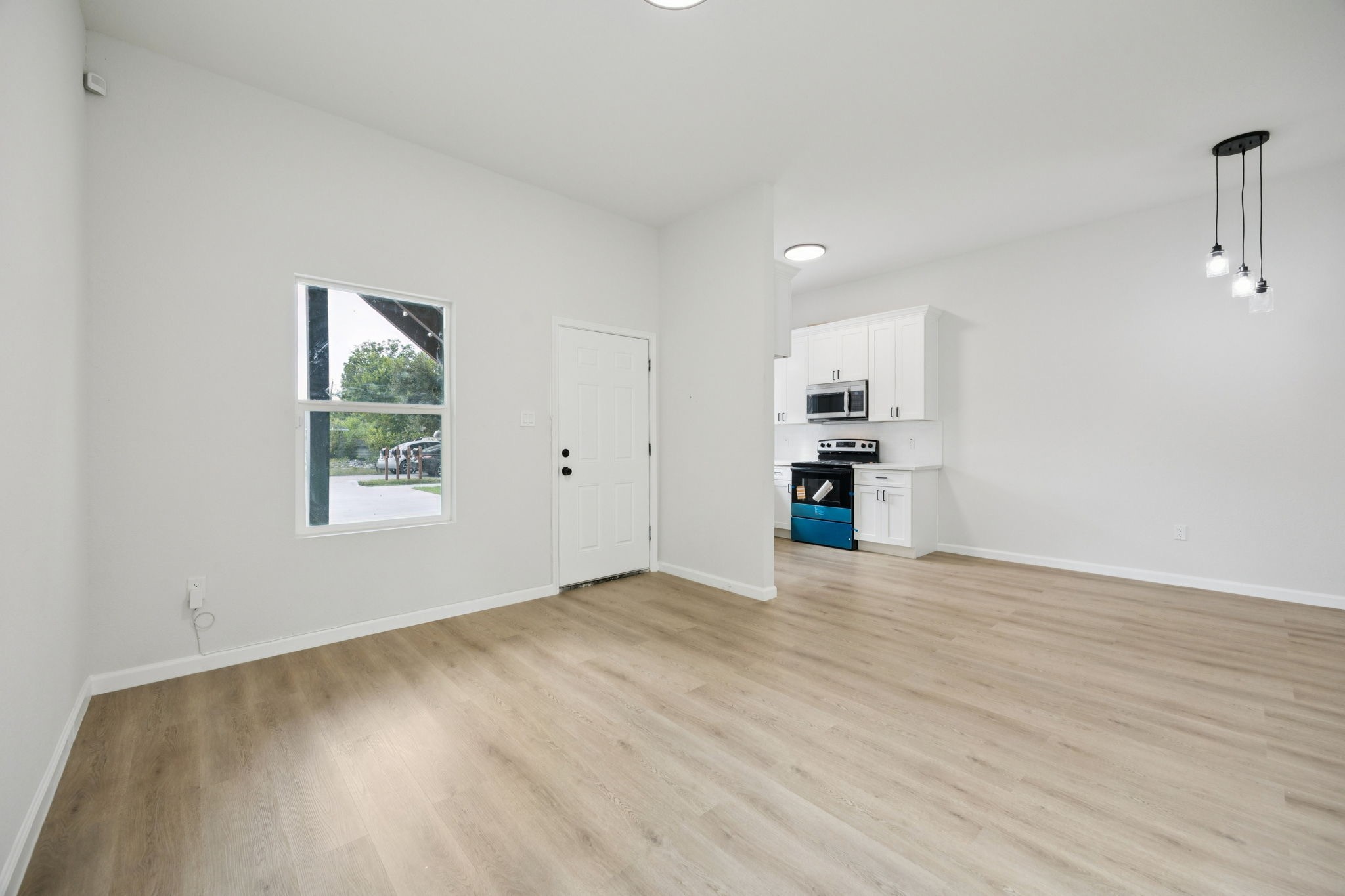301 Cartersville Street, Unit B Houston, TX 77029 - Photo 21 of 23 wooden floor in an empty room with a window