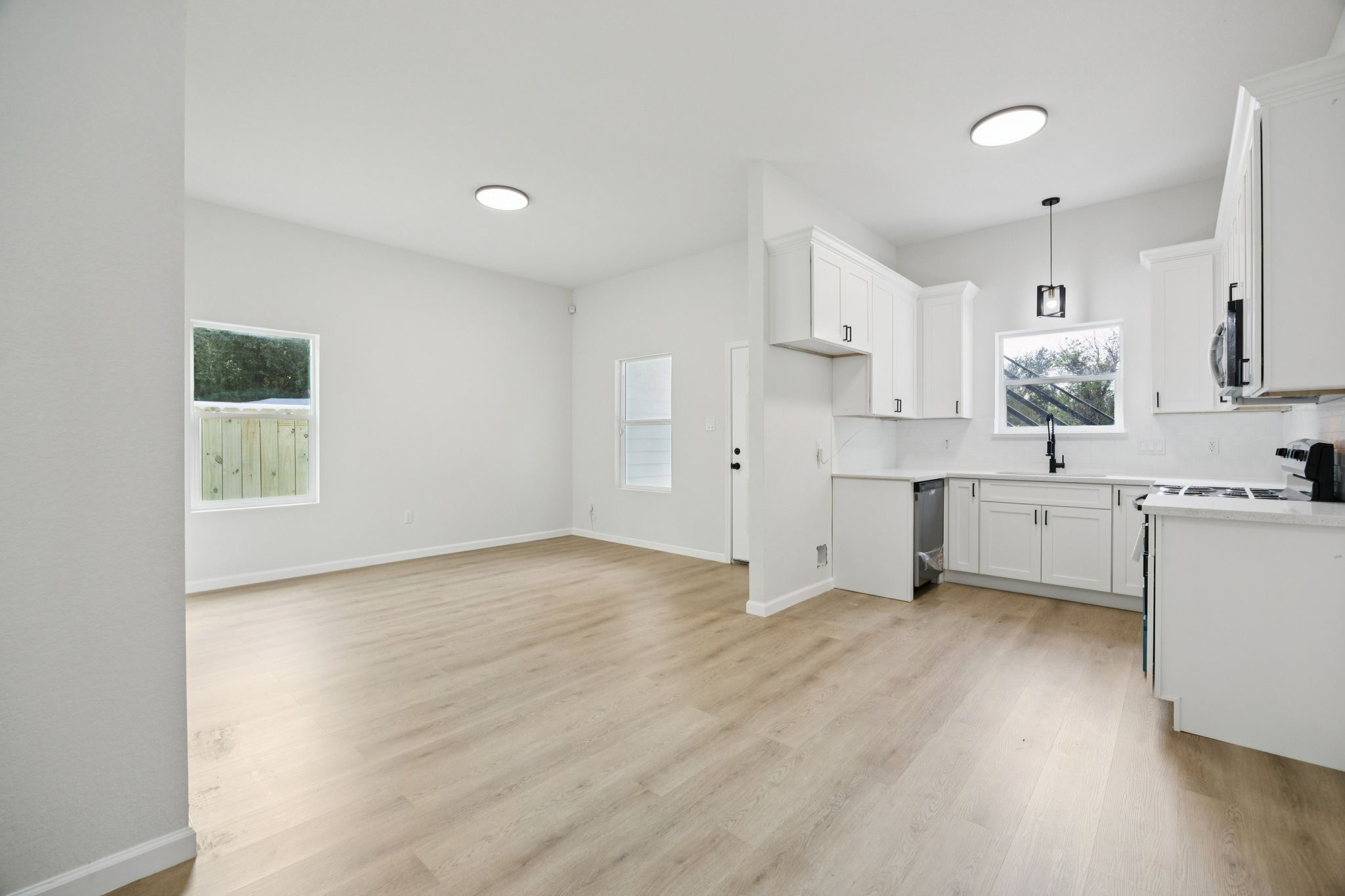 301 Cartersville Street, Unit B Houston, TX 77029 - Photo 5 of 23 a view of kitchen with wooden floor and electronic appliances