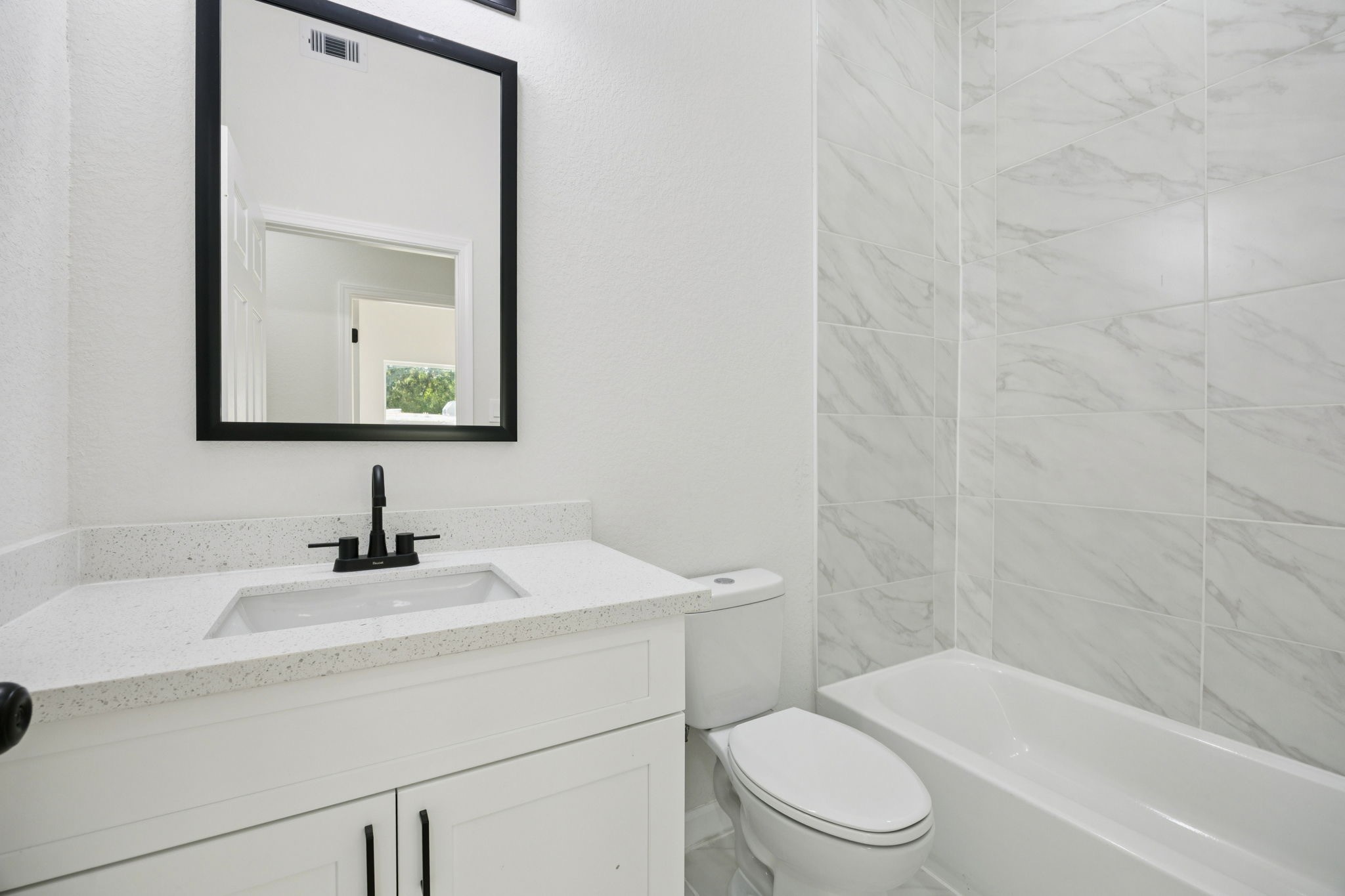 301 Cartersville Street, Unit B Houston, TX 77029 - Photo 8 of 23 a bathroom with a toilet a sink and mirror