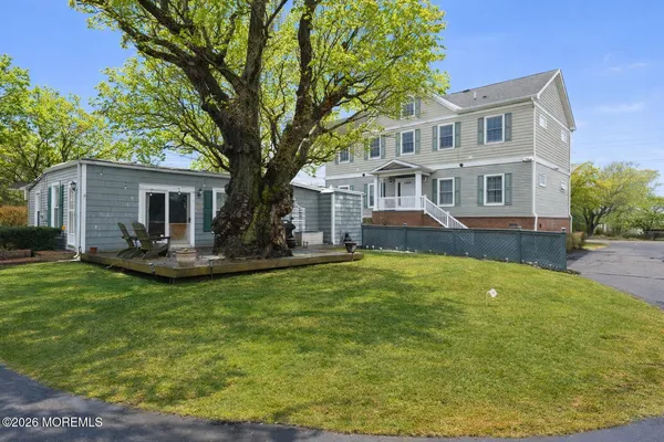a front view of house with yard and green space