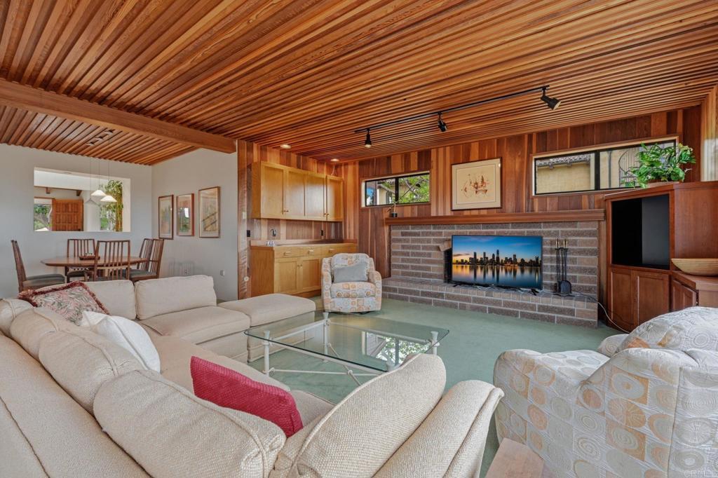 1042 Hymettus Avenue Encinitas, CA 92024 - Photo 12 of 51 a living room with furniture a flat screen tv and a fireplace