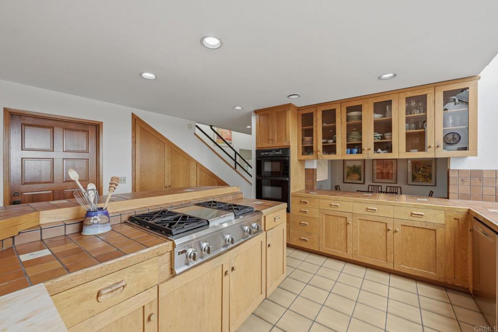 1042 Hymettus Avenue Encinitas, CA 92024 - Photo 17 of 51 a kitchen with a stove and white cabinets