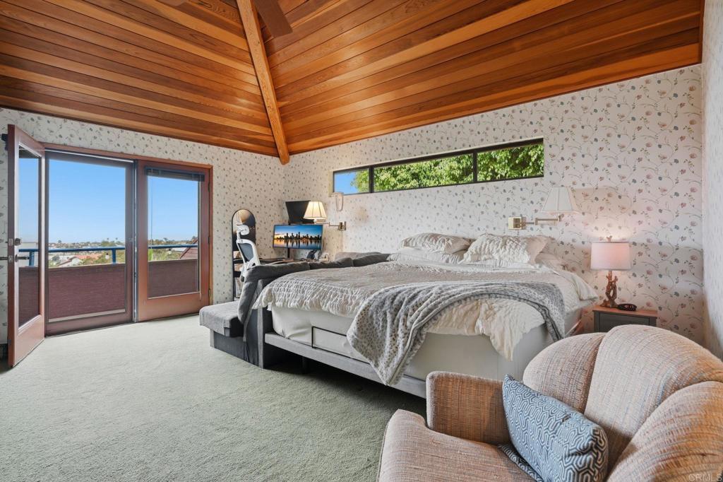 1042 Hymettus Avenue Encinitas, CA 92024 - Photo 25 of 51 a spacious bedroom with a bed and large windows