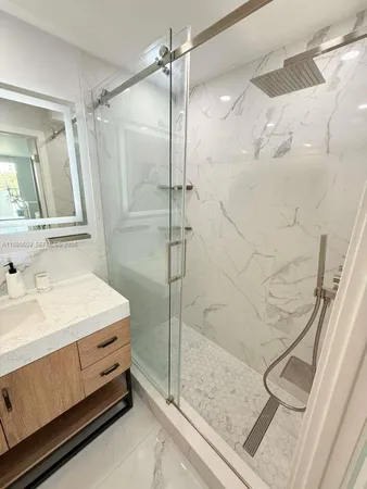 a bathroom with a double vanity sink a mirror and shower