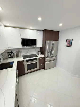 a kitchen with granite countertop a refrigerator and a stove