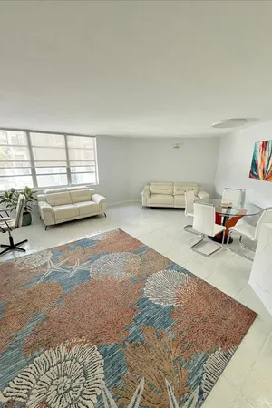 a view of a livingroom with furniture and a rug