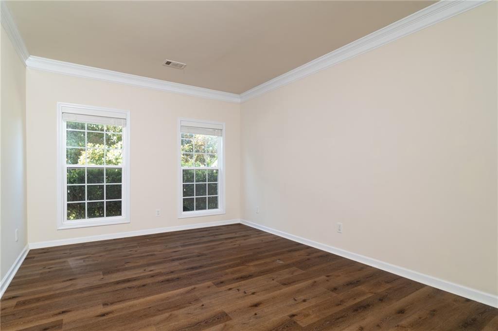 206 Sawtooth Court Canton, GA 30114 - Photo 13 of 43 an empty room with wooden floor and windows