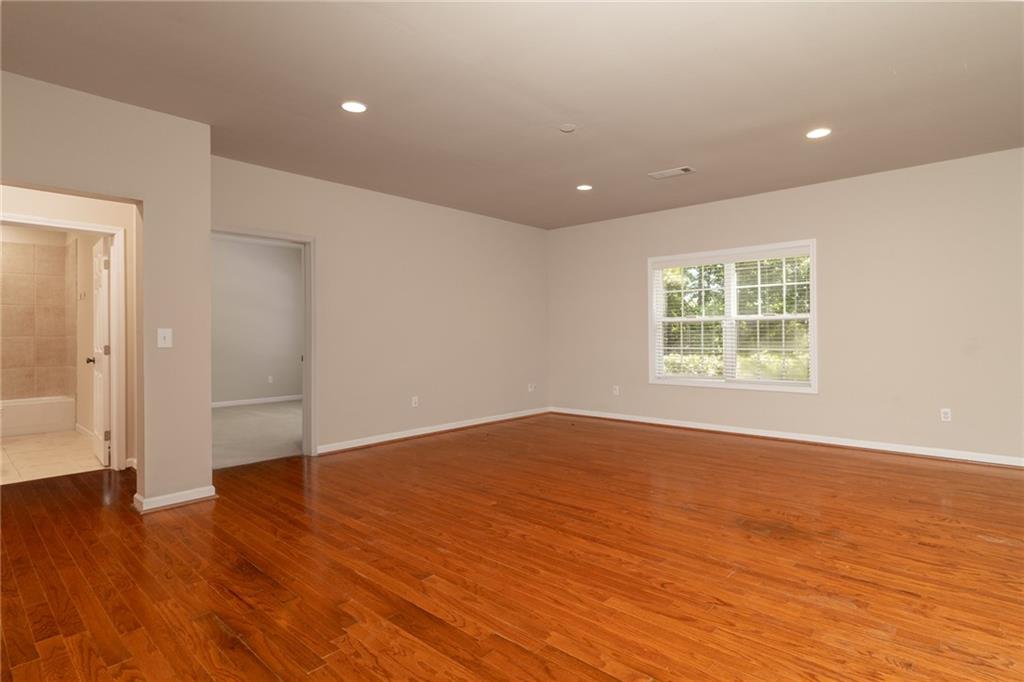 206 Sawtooth Court Canton, GA 30114 - Photo 28 of 43 an empty room with wooden floor and windows