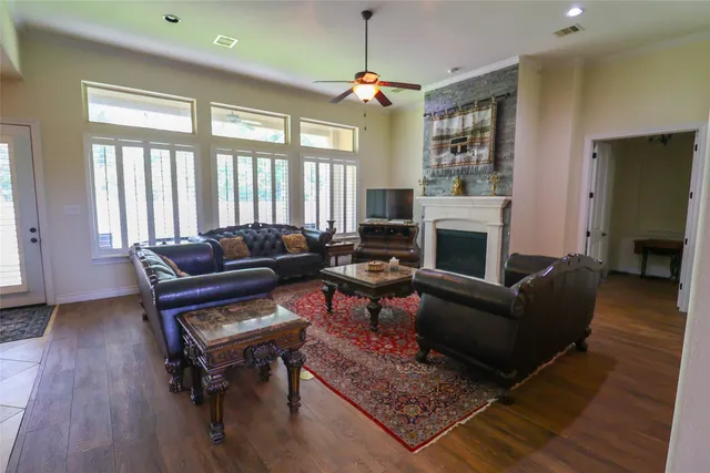 a living room with furniture a fireplace and a table