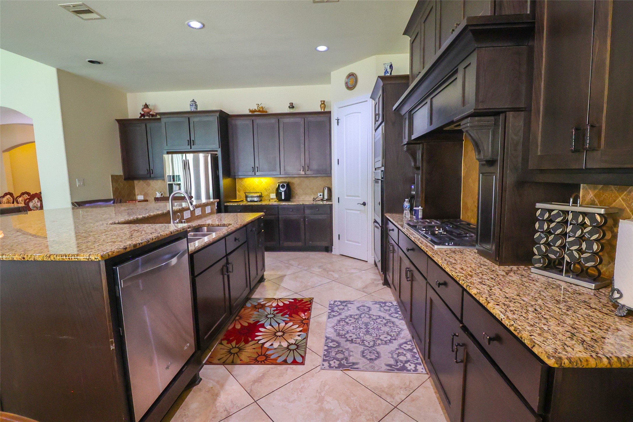 2406 Barclay Lake Lane Spring, TX 77388 - Photo 16 of 50 a kitchen with stainless steel appliances granite countertop a stove a sink dishwasher and a microwave