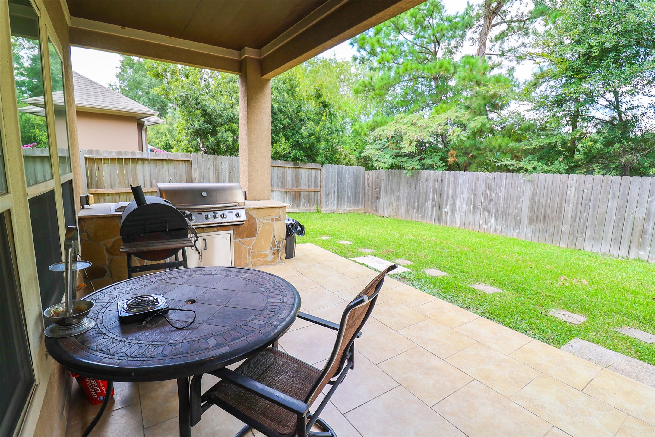 2406 Barclay Lake Lane Spring, TX 77388 - Photo 50 of 50 a view of a backyard with table and chairs potted plants and wooden fence