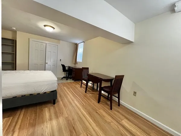 a bedroom with a bed and a table