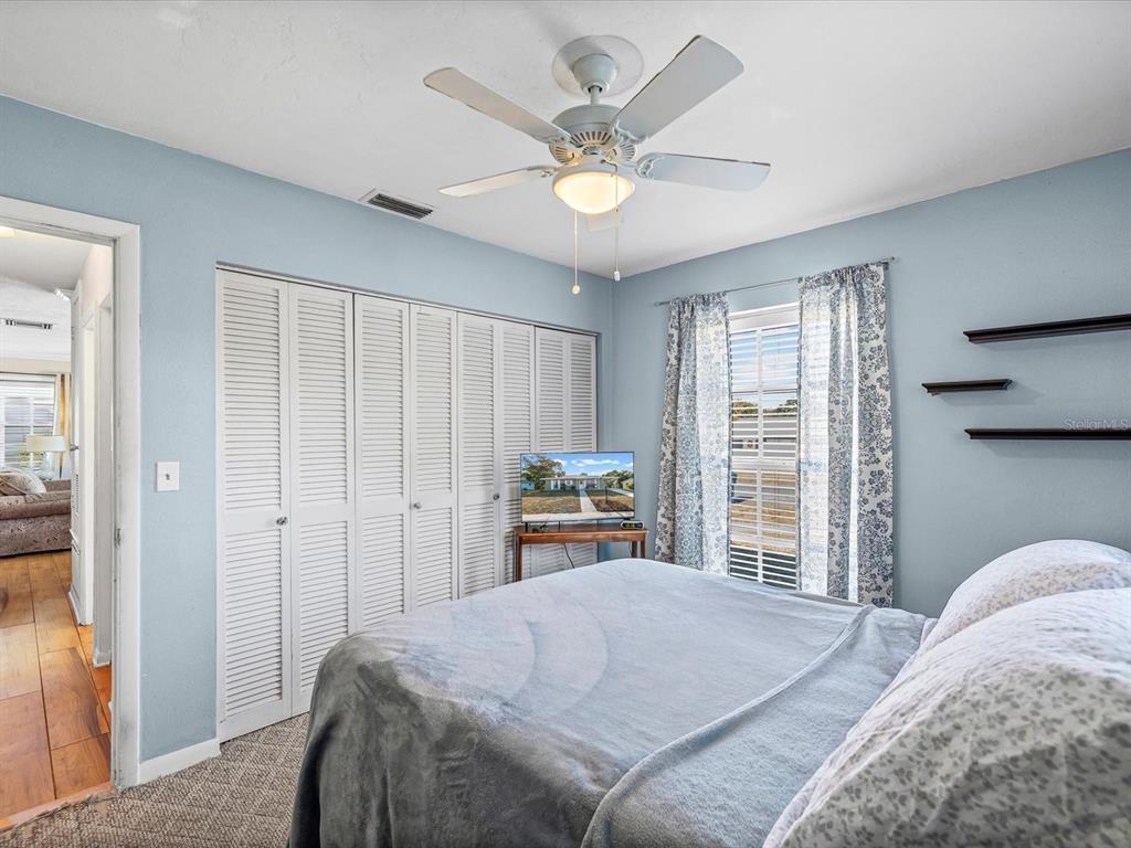 444 Edgehill Avenue Spring Hill, FL 34606 - Photo 25 of 32 a bedroom with a bed and a large window with the outer view