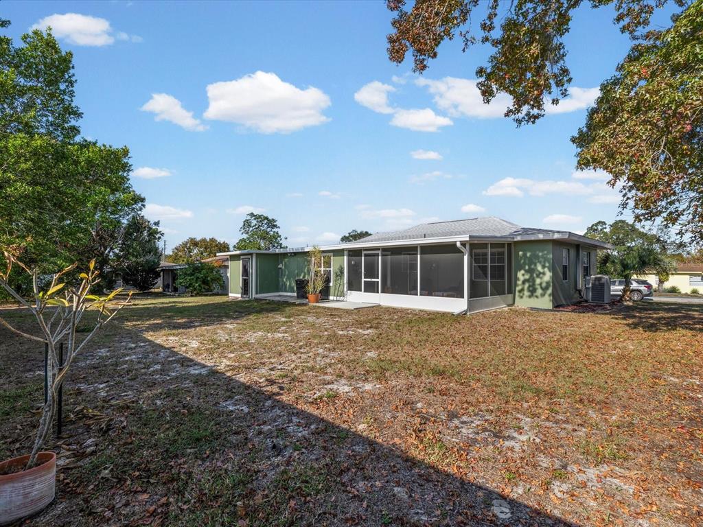 444 Edgehill Avenue Spring Hill, FL 34606 - Photo 32 of 32 a front view of a house with a yard and garage