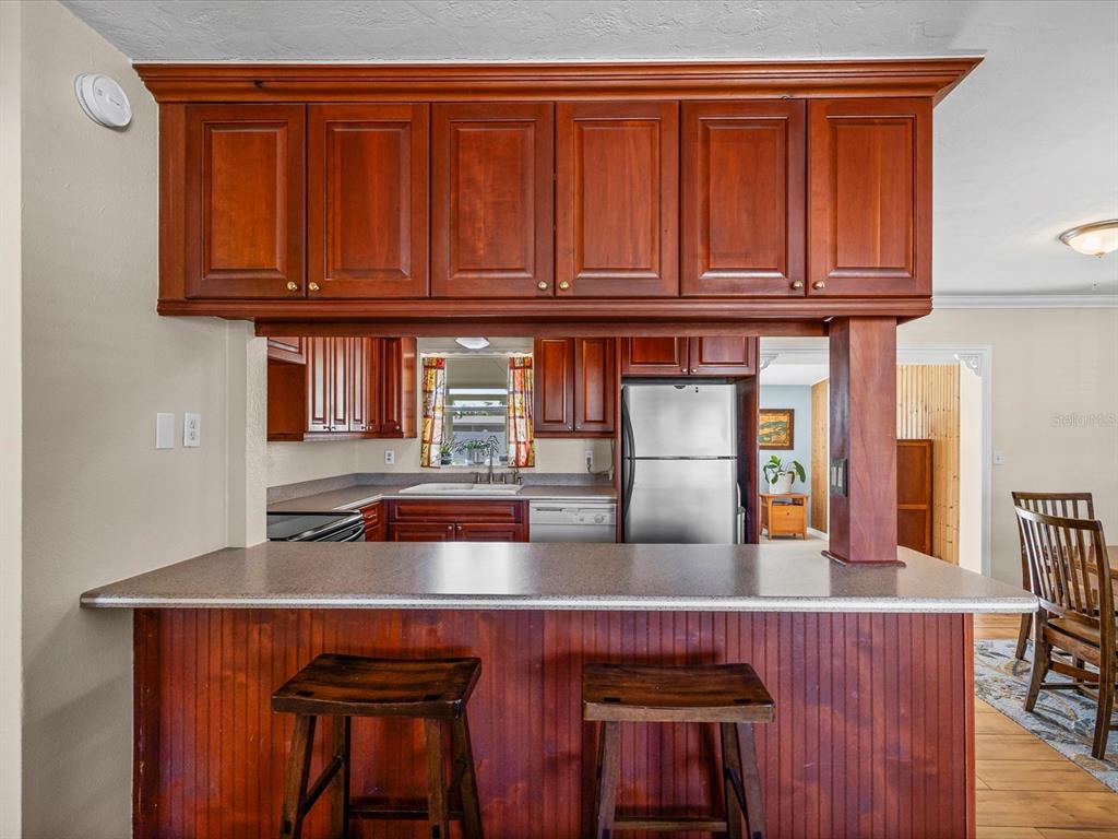 444 Edgehill Avenue Spring Hill, FL 34606 - Photo 9 of 32 a kitchen with stainless steel appliances granite countertop a sink and wooden cabinets