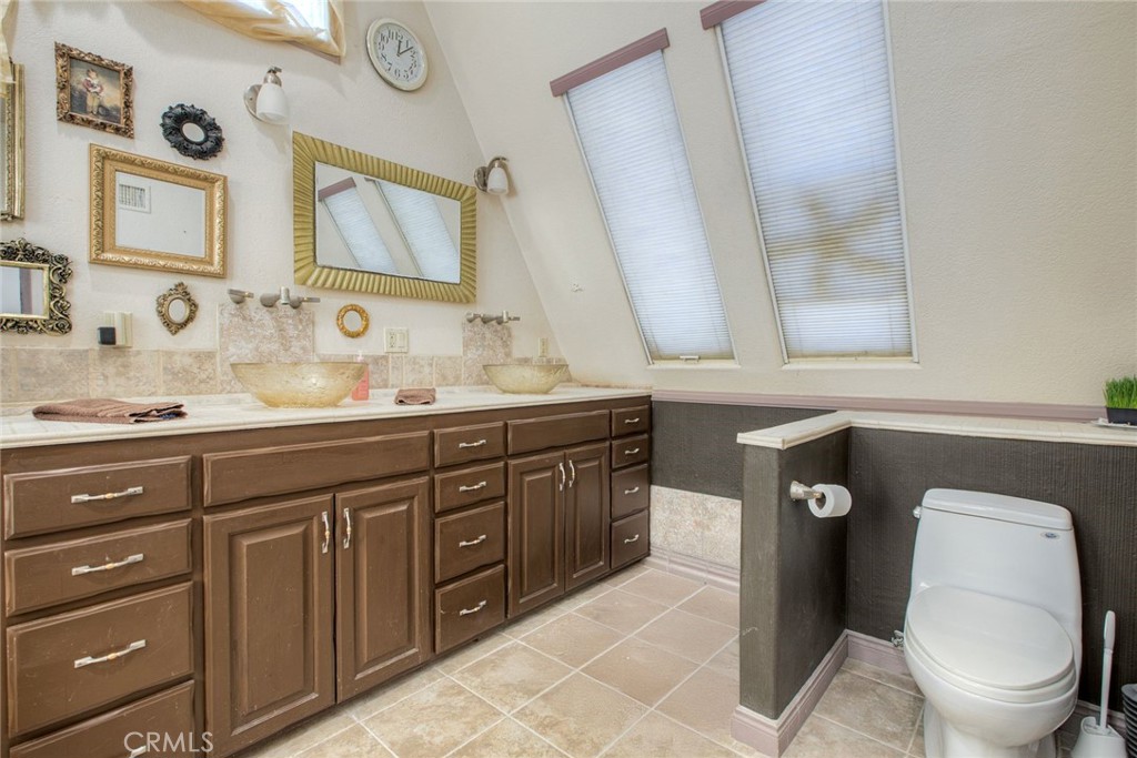 4434 Brodea Lane Fallbrook, CA 92028 - Photo 27 of 38 a bathroom with a double vanity sink and a mirror