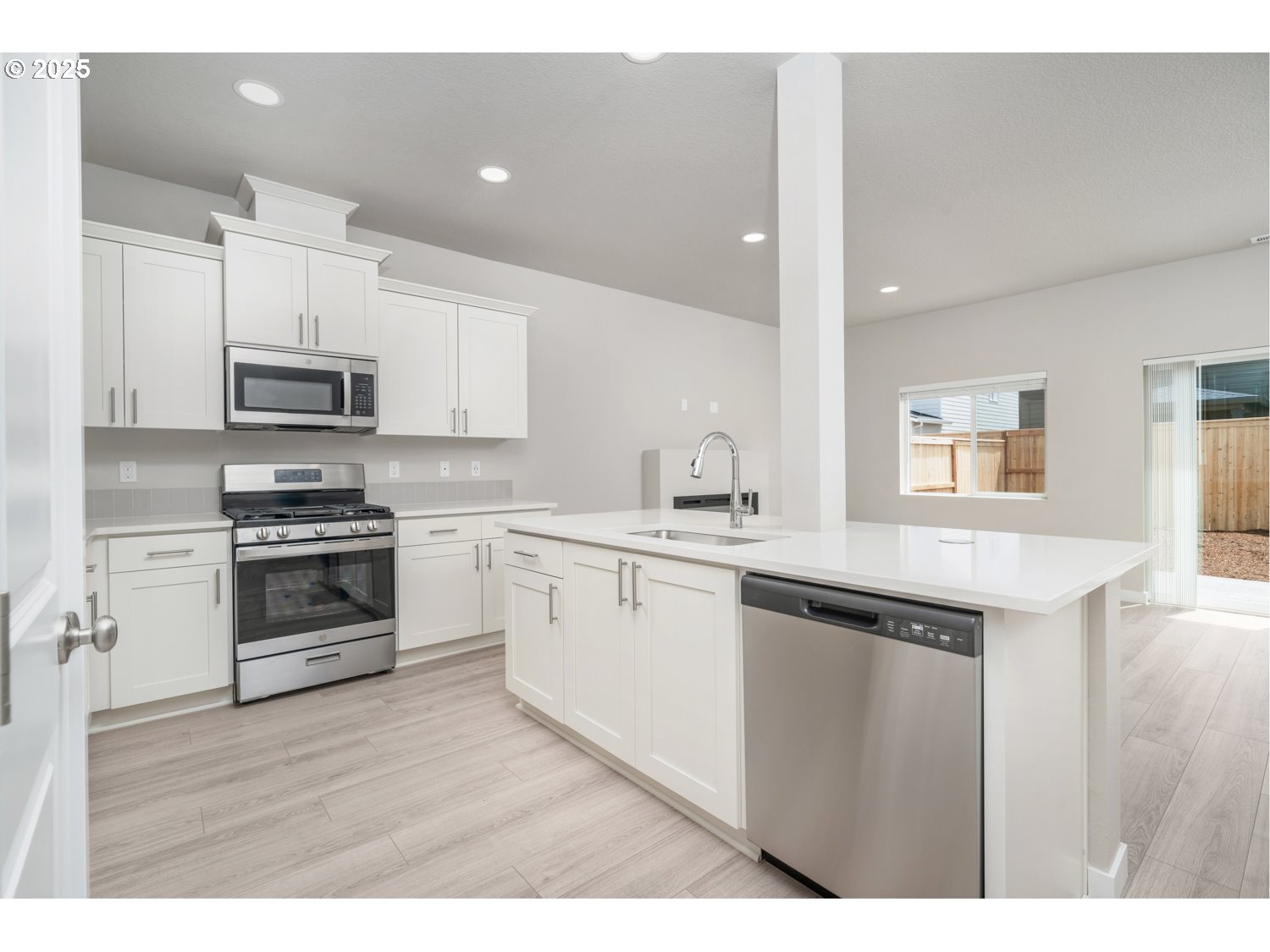 2794 South Ivy Street Cornelius, OR 97113 - Photo 22 of 24 a kitchen with granite countertop a stove top oven and sink