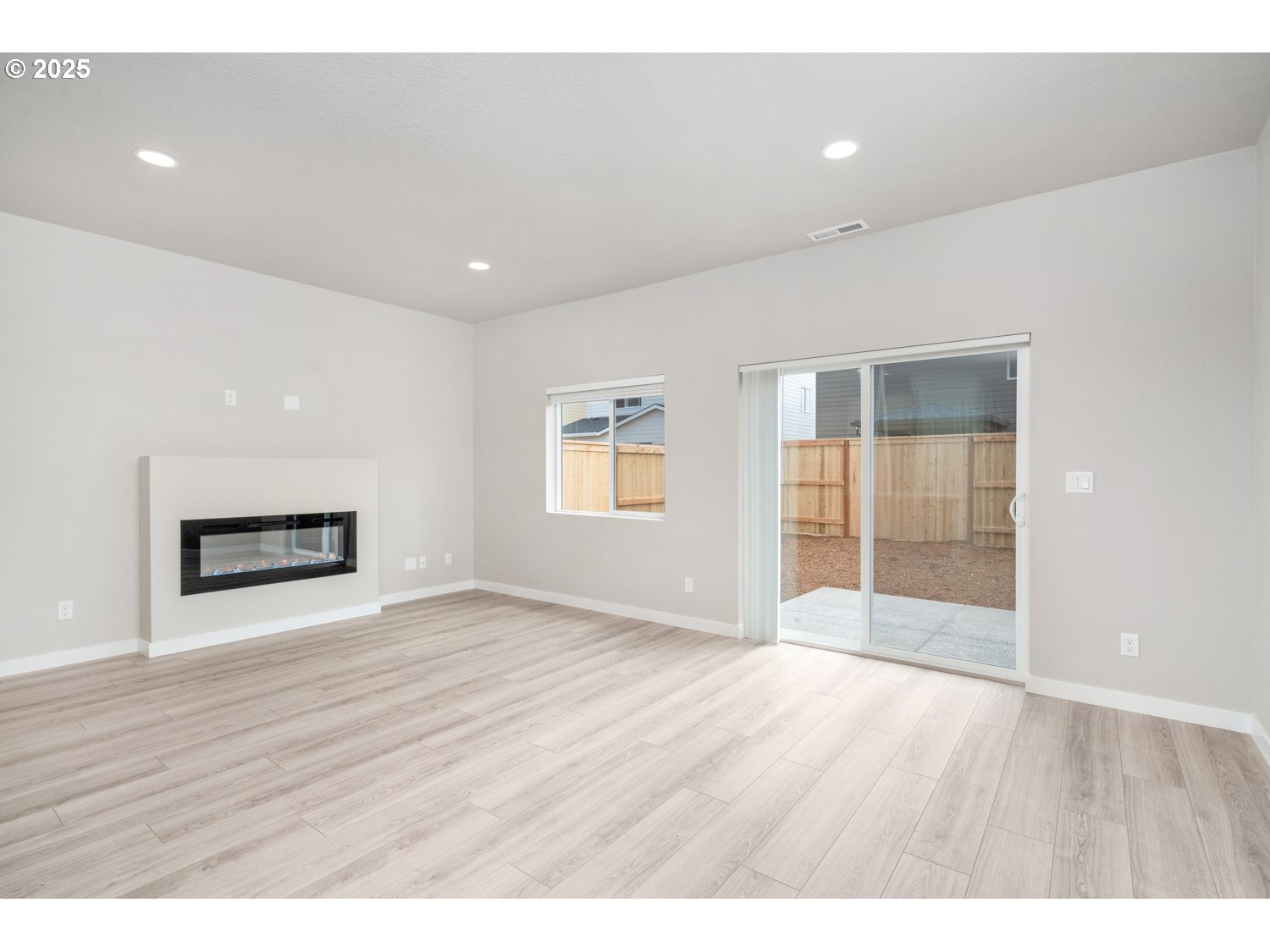 2794 South Ivy Street Cornelius, OR 97113 - Photo 3 of 24 a view of an empty room with wooden floor and a window