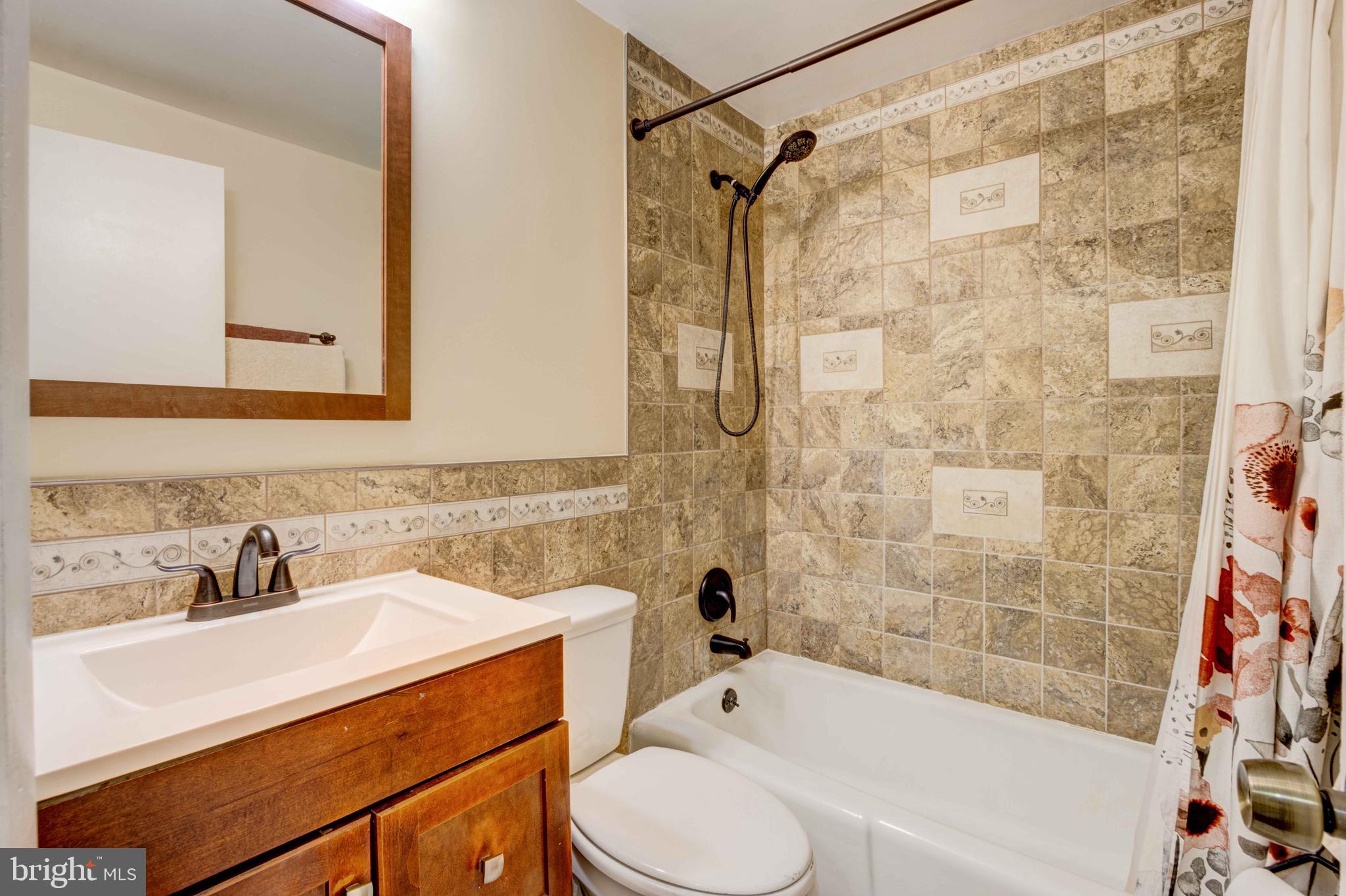 5621 Chelwynd Road Halethorpe, MD 21227 - Photo 11 of 22 a bathroom with a sink toilet and shower