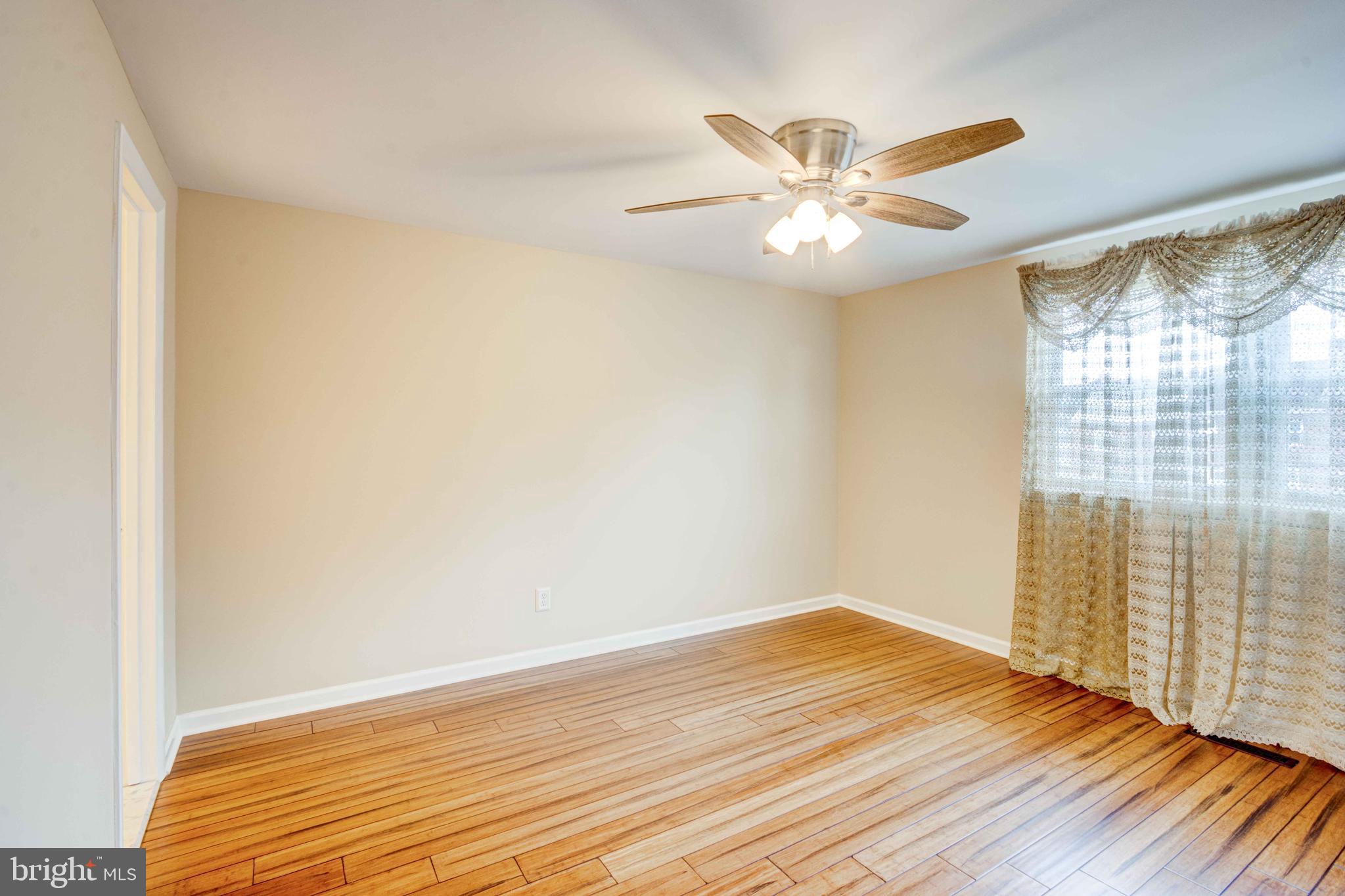 5621 Chelwynd Road Halethorpe, MD 21227 - Photo 13 of 22 a view of an empty room with wooden floor and a window