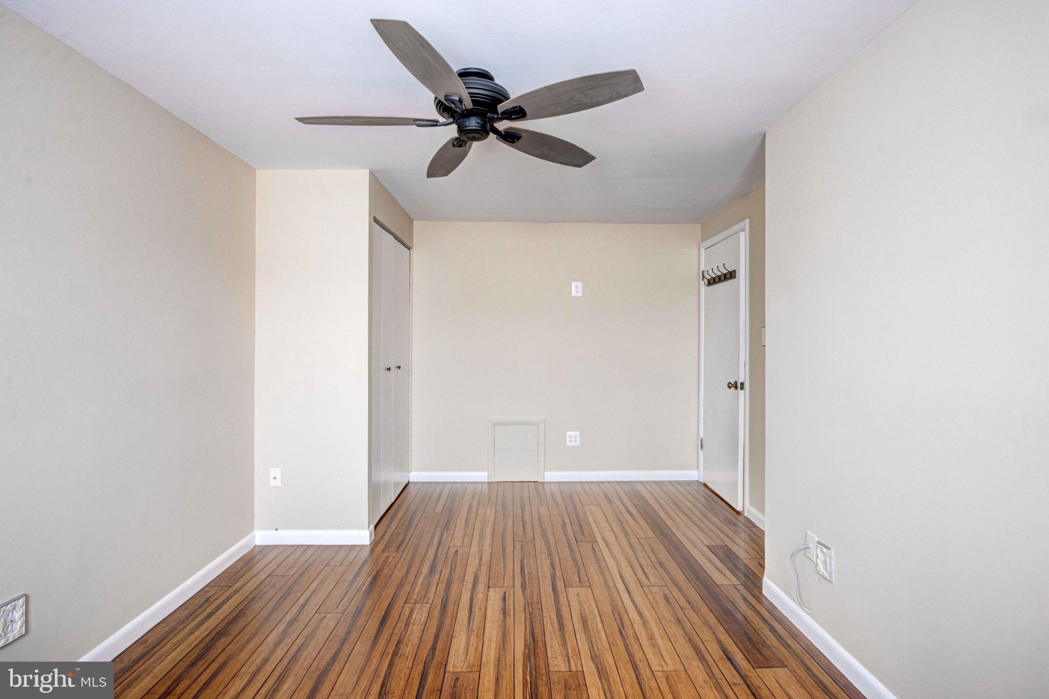 5621 Chelwynd Road Halethorpe, MD 21227 - Photo 17 of 22 a view of a room with wooden floor a ceiling fan