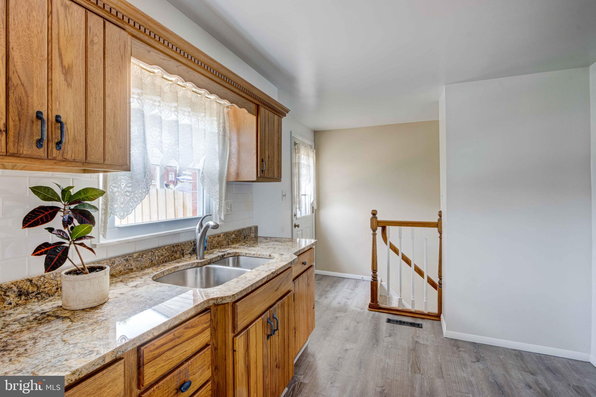 5621 Chelwynd Road Halethorpe, MD 21227 - Photo 7 of 22 a kitchen with granite countertop a sink a counter top space and cabinets