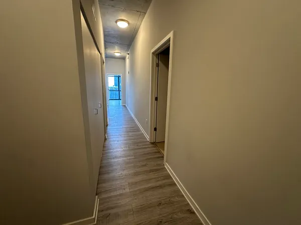a view of a hallway with wooden floor