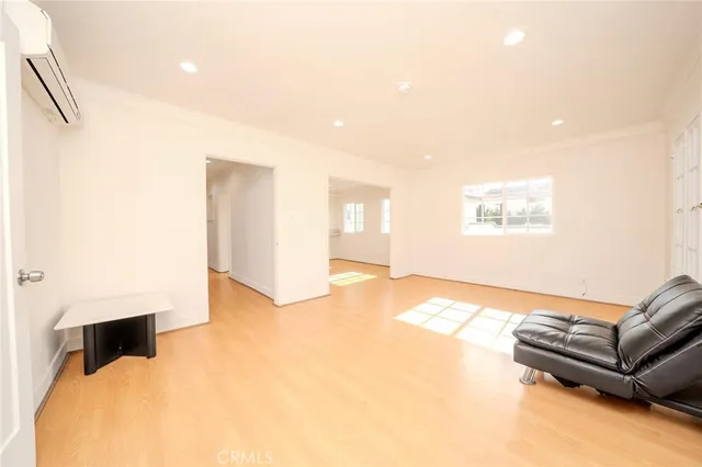 a living room with furniture and a hard wood floor