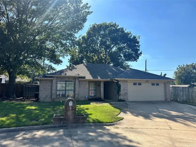a view of a white house with a yard