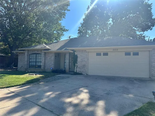 a view of a house with a yard and garage