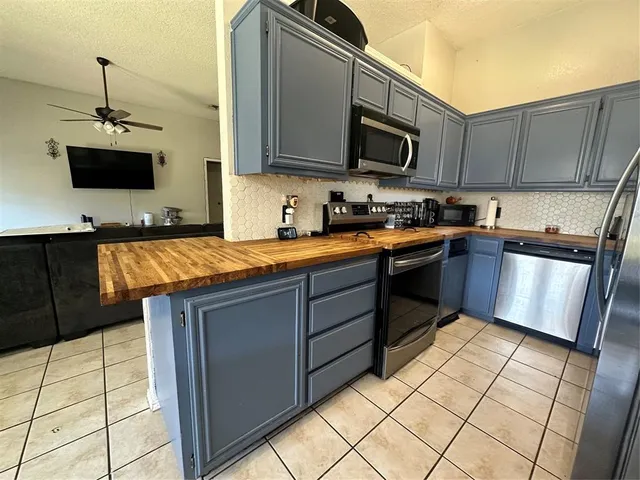 a kitchen with stainless steel appliances granite countertop a sink stove and microwave