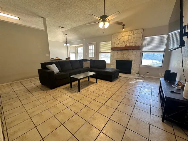 a living room with furniture and a fireplace