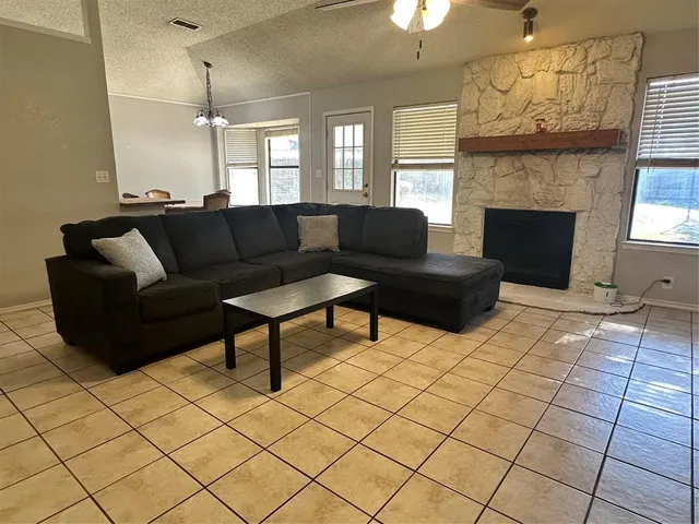 a living room with furniture and a fireplace