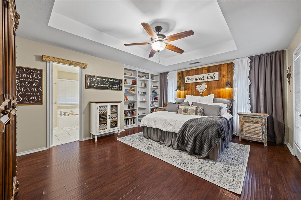 112 Springfield Lane Red Oak, TX 75165 - Photo 16 of 40 a bedroom with a bed a window and dresser