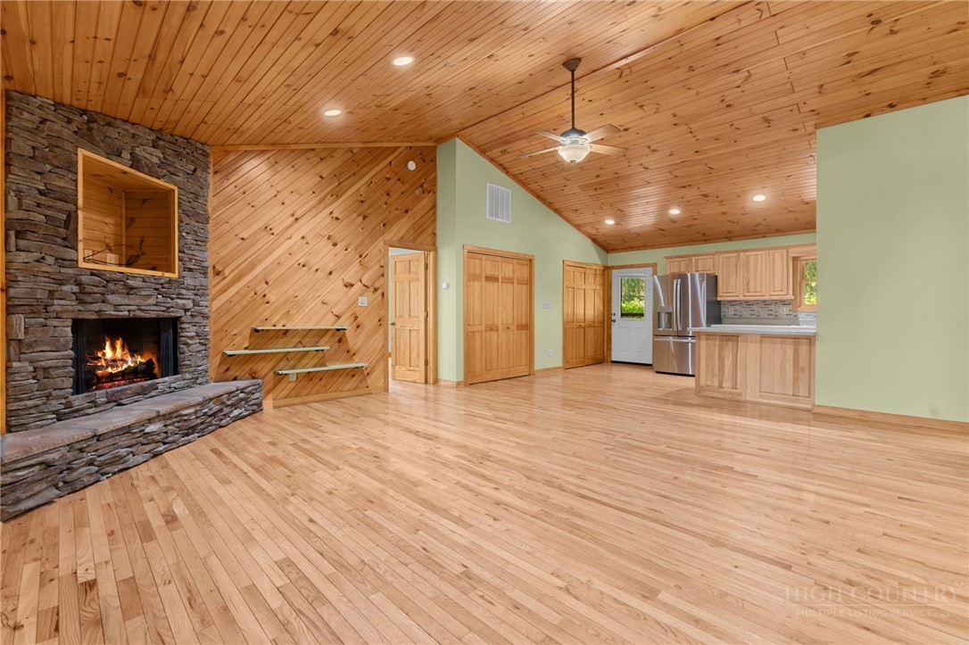 148 Woodby Ridge Road Vilas, NC 28692 - Photo 5 of 33 a view of a livingroom with wooden floor and a fireplace
