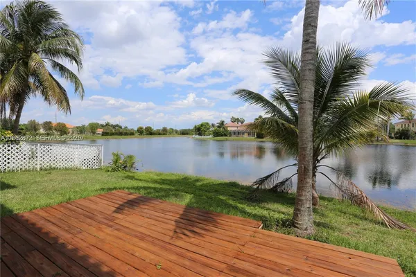 a view of a lake with houses in the background