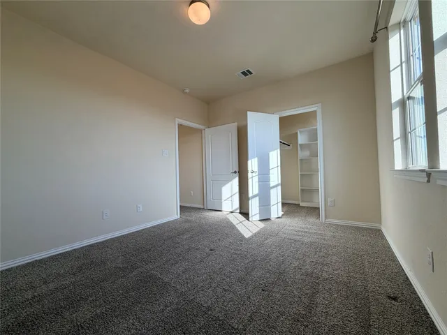 a spacious bathroom with a double vanity sink and a mirror