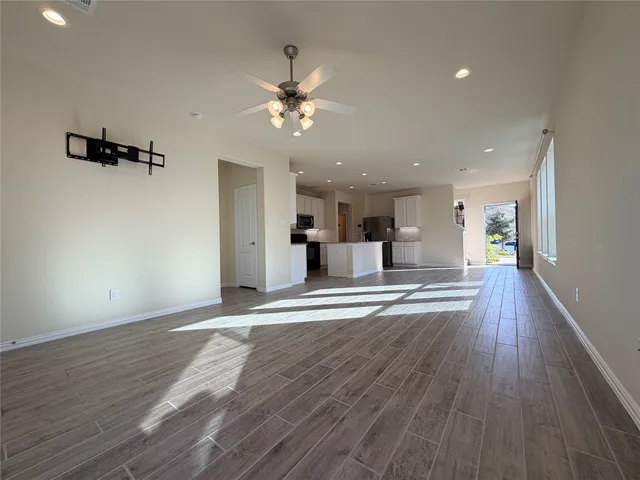 a kitchen with kitchen island a counter top space a refrigerator and a stove