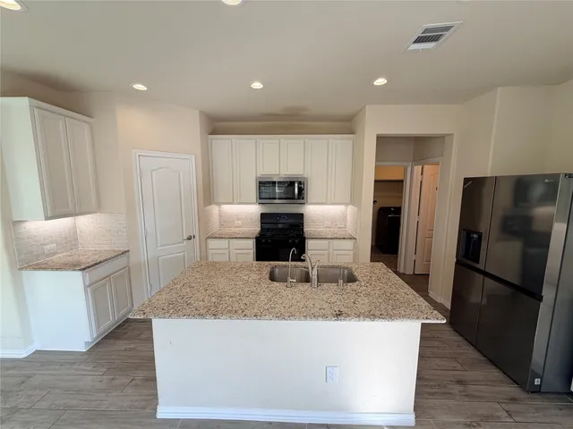 a kitchen with a stove microwave and refrigerator
