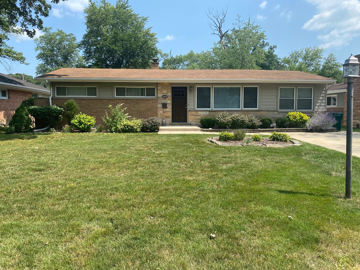 1009 Dell Road Northbrook, IL 60062 - Photo 1 of 15 a front view of house with yard and green space