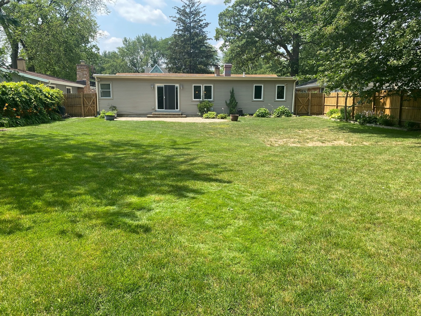 1009 Dell Road Northbrook, IL 60062 - Photo 15 of 15 a house that has a big yard with wooden fence